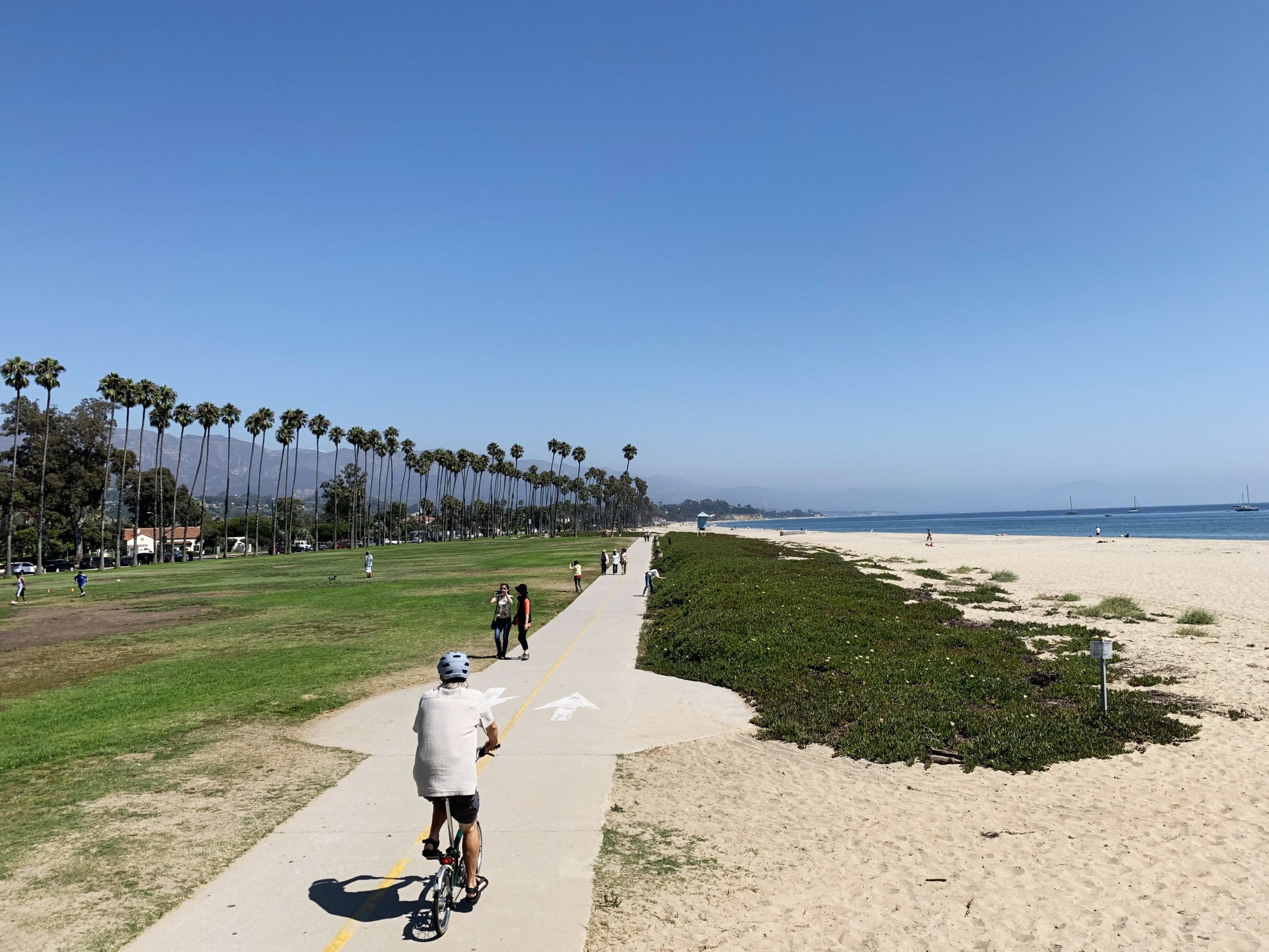 Man riding bike along beach path on West Beach in Santa Barbara