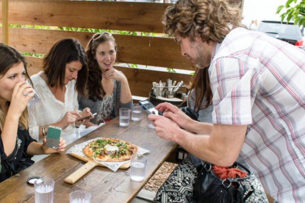 a group of people sitting at a table eating food