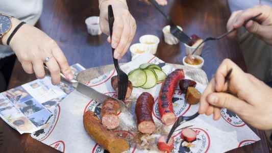 a person cutting food on a plate