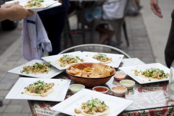 a woman sitting at a table eating food