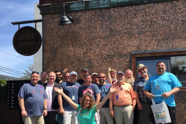a group of people standing in front of a crowd posing for the camera