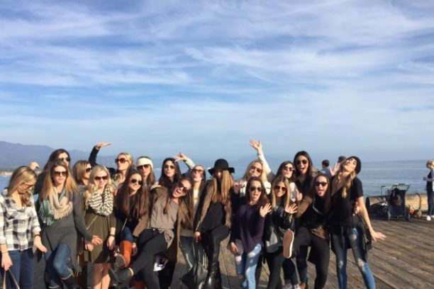 a group of people on a beach posing for the camera