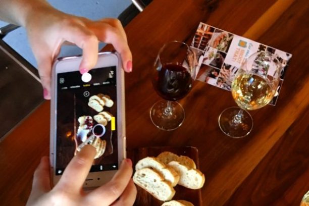 a hand holding a wine glass