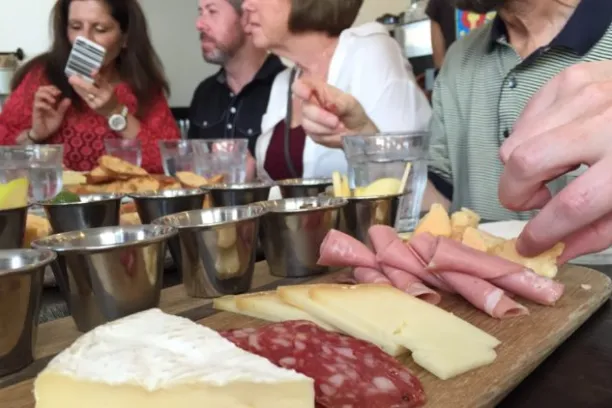 a group of people sitting at a table with food