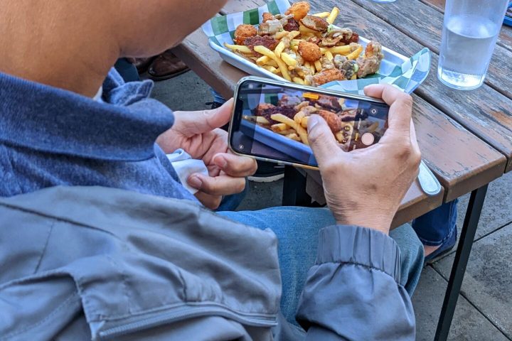 a group of people sitting at a table eating food